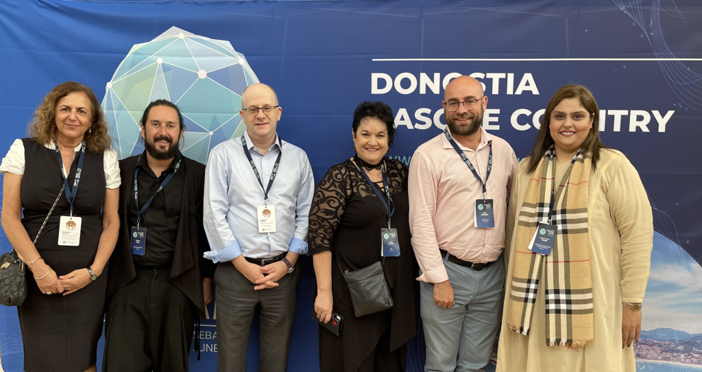 Image of 6 people standing in front of a WFCP banner